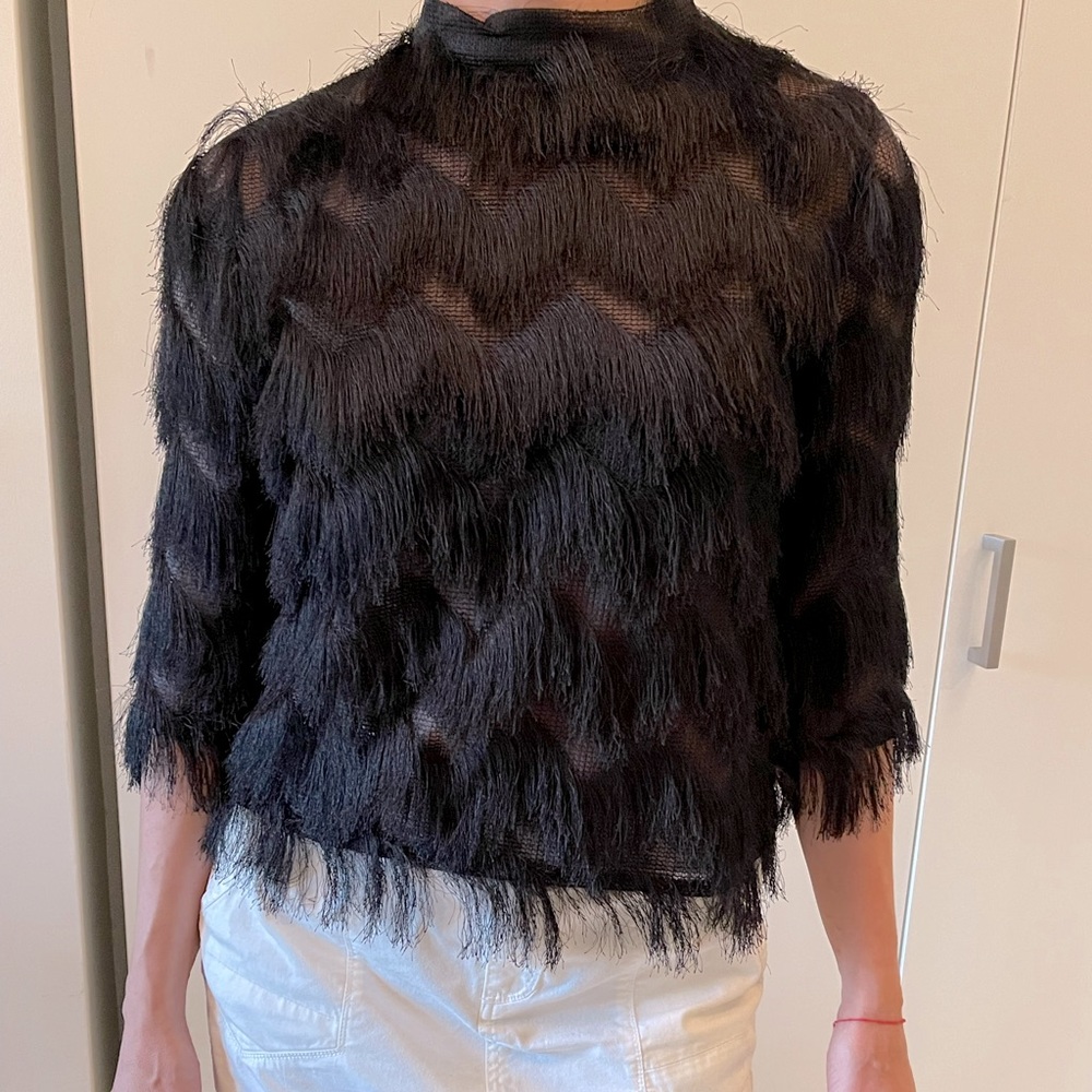 Women’s blouse with threads. Black color